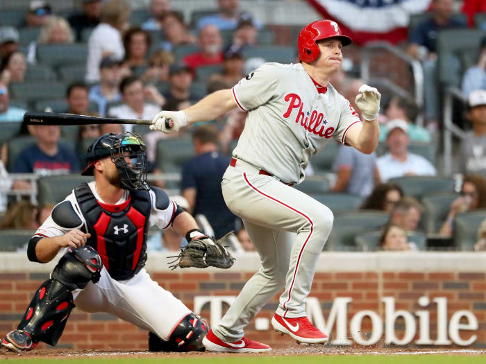 Jul 2, 2019; Atlanta, GA, USA; Philadelphia Phillies right fielder Jay Bruce (23) hits a two RBI double as Atlanta Braves catcher Brian McCann (16) looks on during the fourth inning at SunTrust Park.